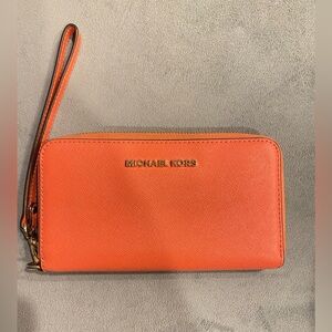 Michael Kors jet set wallet continental wristlet in oranges red coral color.